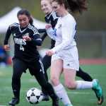 Thunder Mountain's Cierra McCaln, right, drives the ball against Juneau-Douglas' Meranda Frenzel, left, and Kallen Hoover during their game at Thunder Mountain HIgh School on Tuesday. JDHS won 5-0.