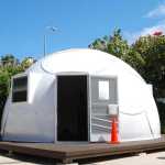 In this Friday, April 22, 2016 photo, a dome-shaped shelter is shown at the First Assembly of God church in Honolulu. The church is looking into an unexpected solution to state's homeless crisis: they're planning to erect Alaska-made igloos to house homeless families. The snow-inspired dome-shape structures would appear at first glance to be a misfit among the island state's palm trees and sandy beaches, but their bright fiberglass exterior reflects the sun, shading those inside. (AP Photo/Caleb Jones)