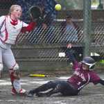 Ketchikan's J. Miller slides safely into home as Juneau-Douglas' Morgan Balovich waits for the throw during their game at Melvin Park on Friday.