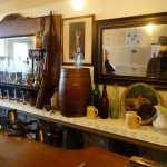 A mannequin of Soapy Smith, created by Martin Itjen, looks back at tour members through a mirror in Jeff Smith's Parlor Museum.