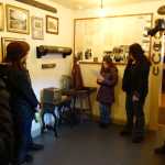A Skagway School fourth-grader tells visitors the history of an antique gum ball machine at the Jeff Smith's Parlor Museum reopening on Saturday, April 30.