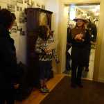 A Skagway School fourth-grader tells visitors about a coffee grinder in the Jeff Smith's Parlor Museum on Saturday, April 30.