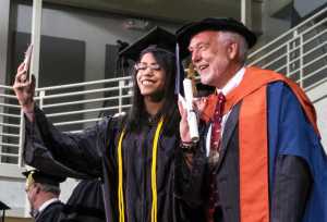 University of  Alaska Southeast Chancellor Richard A. Caulfield poses for a selfie with a recent graduate during the 2016 UAS commencement ceremony held Sunday.