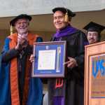 Edward Thomas, center, holds his honorary doctorate of law degree as University of Alaska Chancellor Richard Caulfield, left, and Vice Chancellor Joe Nelson look on during the 2016 UAS commencemenet ceremony on Sunday.