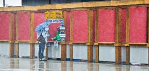 Nick Millonzi, a tour broker for M&M Tours, shows his work ethic by manning his sales booth downtown on a rainy start to the cruise ship season Monday. Millonzi is in his eighth season selling tours.