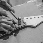 Juneau artist Geoerge Gress works on a guitar.