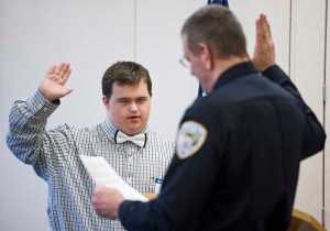 David Timothy is sworn in by Chief of Police Bryce Johnson as a "Friend of the Force" during the department's quarterly awards ceremony on Friday.