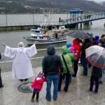 Pastor Suellen Bahleda, of Resurrection Lutheran Church, blesses the fishing vessel San Juan during the Blessing of the Fleet and Dedication of Names at the Alaska Commercial Fishermen's Memorial in Juneau on Saturday, May 7, 2016.