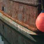 Reflecting back a WW II era ship in Kodiak. Photo by Kathleen Samalon.
