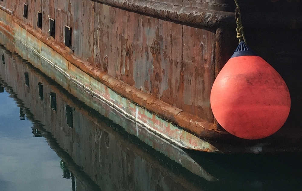 Reflecting back a WW II era ship in Kodiak. Photo by Kathleen Samalon.