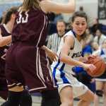 In this February 2016 photo, Thunder Mountain's Ava Tompkins looks to drive against Ketchikans' Courtney Kemble, front, and Alexis Biggerstaff, back, during a game at TMHS. Tompkins has signed to play college basketball at Wesleyan University in Connecticut.
