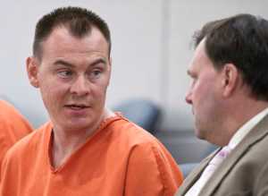 Brian Hogan, 33, speaks to his attorney, Assistant Public Defender Eric Hedland, during his arraignment in Juneau District Court in July 2015.