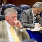 Sen. Pete Kelly, R-Fairbanks, right, and Sen. Charlie Huggins, R-Wasilla, listen to debate on the oil and gas tax credits bill during the 121st day of the legislative session on Wednesday.