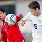 Juneau-Douglas' Sherrod Miller, left, competes against Thunder Mountain's Riley Lawlar for the ball during the game at TMHS on Wednesday.