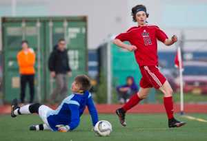 Juneau-Douglas' Brysen Mitchell, right, watches his ball roll into the goal after beating Thunder Mountain's goalie John Seymour during the game at TMHS on Wednesday.