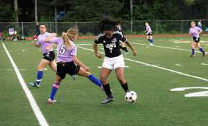 JDHS' Malia Miller, right, and TMHS' Meghan Penrose, left,  battle it out on the field on Friday nights game at Adair Kennedy Memorial Park