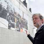 Dan Hopson leads an Art Walk tour in downtown Juneau in May that includes a mural on the side of the Juneau Public Library by Dan DeRoux.