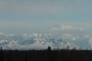 This photo taken Sunday, April 24, 2016, in Talkeetna, Alaska, shows Denali partially obscured by clouds. The U.S. Army helped the National Park Service by using Chinook helicopters to fly food and materials to set up base camps at the 7,200-foot and 14,000-foot level to assist climbers on North America's tallest mountain. (AP Photo/Mark Thiessen)