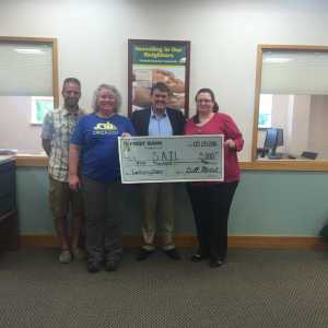 First Bank vice president Robert Anderson (second from right), presents a $5,000 check to SAIL for all donations made in their Juneau branches during this past winter's holiday donor matching campaign. From SAIL (left to right): assistant director Tristan Knutson-Lombardo, SAIL Board vice president Elizabeth Spence and SAIL Board president Kate Burkhart.