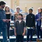 Juneau Community Charter School teacher Tom Schwartz acknowledges fifth-grade student James Ware, center, during the school's Moving On Ceremony at Northern Light United Church on Wednesday. The other fifth-grade students from the left are: Elizabeth Stitz, Ryah Phillips, Benjamin Goldstein, Clinton McQueen, Marlla Cabrigas-Blatnick and Sandra Bouvier.