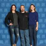 The leads of the CBS show "Supergirl at C2E2 in 2016 pose on either side of Todd Jones. Melissa Marie Benoist who plays Supergirl is on the right and Chyler Leigh West who plays Alexandra "Alex" Danvers is on the left.