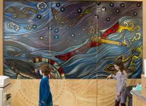 Sasha Morrison, 8, left, and her sister, Anita, 10, view a portion of artist Evon Zerbetz's glass dividing wall in the Father Andrew P. Kashevaroff State Library, Archives, and Museum. The children were taking part of a family day tour of the new facility. The building opens to the public on Monday, June 6.