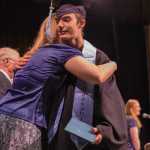 Yaaḵoosgé Daakahídi senior Cain Ramsey hugs his teacher after receiving his diploma Sunday during the graduation ceremony at Centennial Hall.