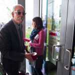 Bob Banghart, deputy director of the State Libraries, Archives and Museums unrolls a red ribbon during the Grand Opening of the Fr. Andrew P. Kashevaroff building housing the State Library, State Archives and State Museum on Monday.