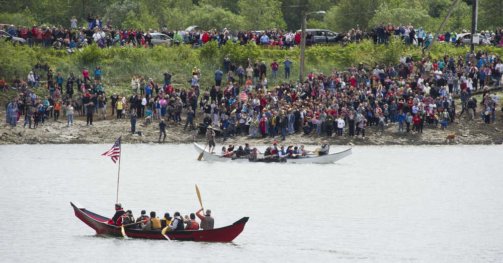 Canoes enter Douglas Harbor for a Coming Ashore Ceremony sponsored by the One People Canoe Society on Wednesday.