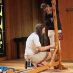 Shgen George and daughter Gabby Kay set up a portable weaving loom during the Ravenstail and Chilkat Weavers Symposium at the Walter Soboleff Building's clan house Wednesday.