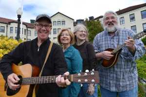 In this June 2 photo, from left, Mike Pierce, Candy Pierce, Julie Schmitts and Ted Howard get together outside the Pioneers Home in Sitka. Their band, Cornsilk, had a reunion over the weekend after a four decade hiatus.