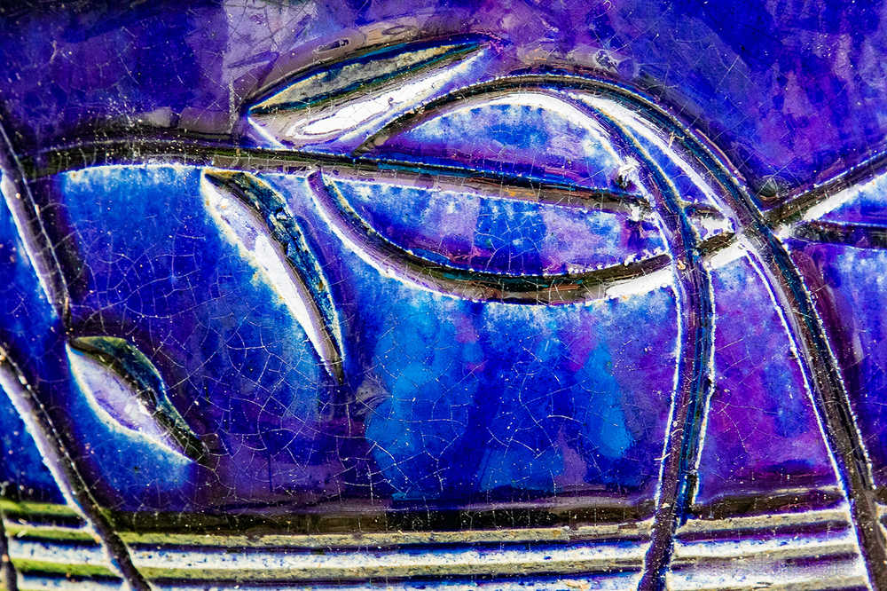 Colorful detail from an old flower pot. Photo by Kerry Howard.