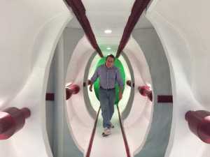Anton Doiron walks down the spaceship hallway of his movie set.