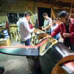 TJ Young, right, paints a totem pole he helped carve at Culture Camp last year in Hydaburg.