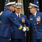 Rear Admiral Michael McAllister, left, takes over as Commander of the U.S. Coast Guard 17th District from Rear Admiral Daniel Abel, right, during a Change of Command ceremony at Elizabeth Peratrovich Hall on Wednesday. The ceremony was overseen by Vice Admiral Charles Ray, Commander of the Pacific Area and Defense Force West, center.