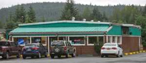 A erratic-behaving man was arrested by police at the Duck Creek Market Friday after making threats of violence while customers were inside.