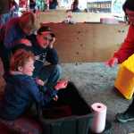 A young Gold Rush Days enthusiast celebrates his gold nugget find Saturday at the GCI booth where people can try their luck at panning for gold during the city's 26th annual celebration of the mining and logging industries.