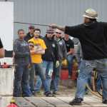 Jackleg drilling competitors look on as one contestant tries to drill his hole the fastest during the 26th Gold Rush Days celebration Saturday at Savikko Park.