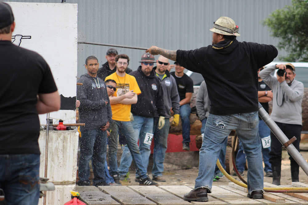 Jackleg drilling competitors look on as one contestant tries to drill his hole the fastest during the 26th Gold Rush Days celebration Saturday at Savikko Park.