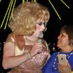 Emcee Daphne DoAll LaChores talks with an audience member at Friday's GLITZ!