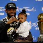 Cleveland Cavaliers' LeBron James answers questions as he holds his daughter Zhuri during a post-game press conference after Game 7 of basketball's NBA Finals Sunday, June 19, 2016, in Oakland, Calif. Cleveland won 93-89. (AP Photo/Eric Risberg)