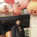 In this May 21, 2016, photo, Austin Sollars poses on the stern of his commercial fishing boat, the Jani-K, at the boat harbor in Seward, Alaska. Sollars, in his early 30s, bought the boat when he was 21, overcoming challenges for young commercial fishermen entering the Alaska fishing fleet, where the average permit holder is now 50. (AP Photo/Dan Joling)