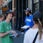 In this June 11 photo, Robert Cleary, left, a marijuana reform advocate with the group NORML, talks with passersby, gathering signatures on a petition to get a pot club initiative on the ballot in the next election, in Denver.