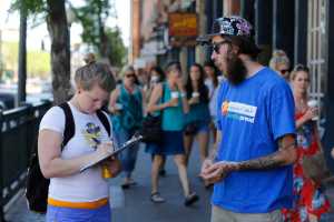 In this June 11 photo, Damian Riniker, right, a marijuana reform advocate with the group NORML, stands by while a passerby signs a petition to get a pot club initiative on the ballot in the next election, in Denver.