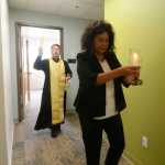 Kenaitze Indian Tribe Executive Director Jaylene Peterson-Nyren leads Father Thomas Andrew of the Holy Assumption of the Virgin Mary Russian Orthodox Church through the halls of the new Tyotkas Elder Center while he blesses it Saturday at the center in Old Town Kenai.