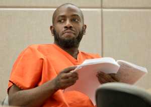 Leron Carlton Graham, 38, reads through court documents during jury selection in Juneau Superior Court on Tuesday. Graham is representing himself on 14 counts of allegedly assaulting a woman and stealing a car in the Lemon Creek area in March.