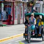 Melissa DeCook of Alaska Pedicab gives a couple a tour on South Franklin Street in early June.