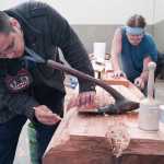 Sam Sheakley, left, and Fred Fulmer work on a 25-foot Raven totem pole at Harborview Elementary School on Wednesday.