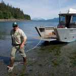 Kevin Murphy, right, chief ranger for the southeast area of Alaska State Parks, steps off a parks' boat to view the new Salamander Cabin at Halibut Cove on Shelter Island on Thursday.