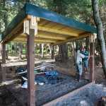 Kevin Murphy, right, chief ranger for the southeast area of Alaska State Parks, and Doug Drexel, southeast maintenance chief, view a shelter built down the beach from the new Salamander Cabin at Halibut Cove on Shelter Island on Thursday. The shelter is available without a reservation.